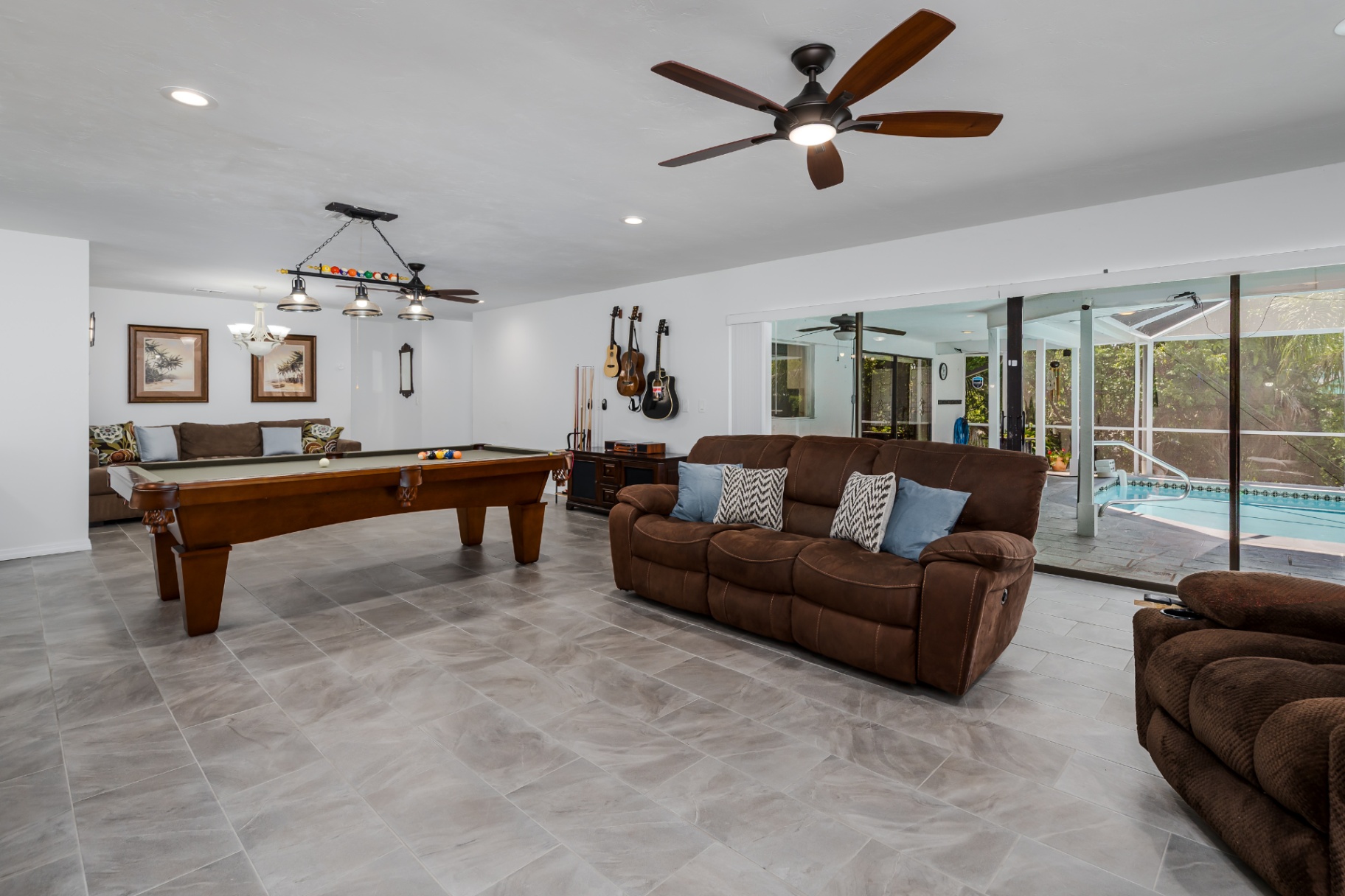 Large rec room with pool table opening to the pool lanai