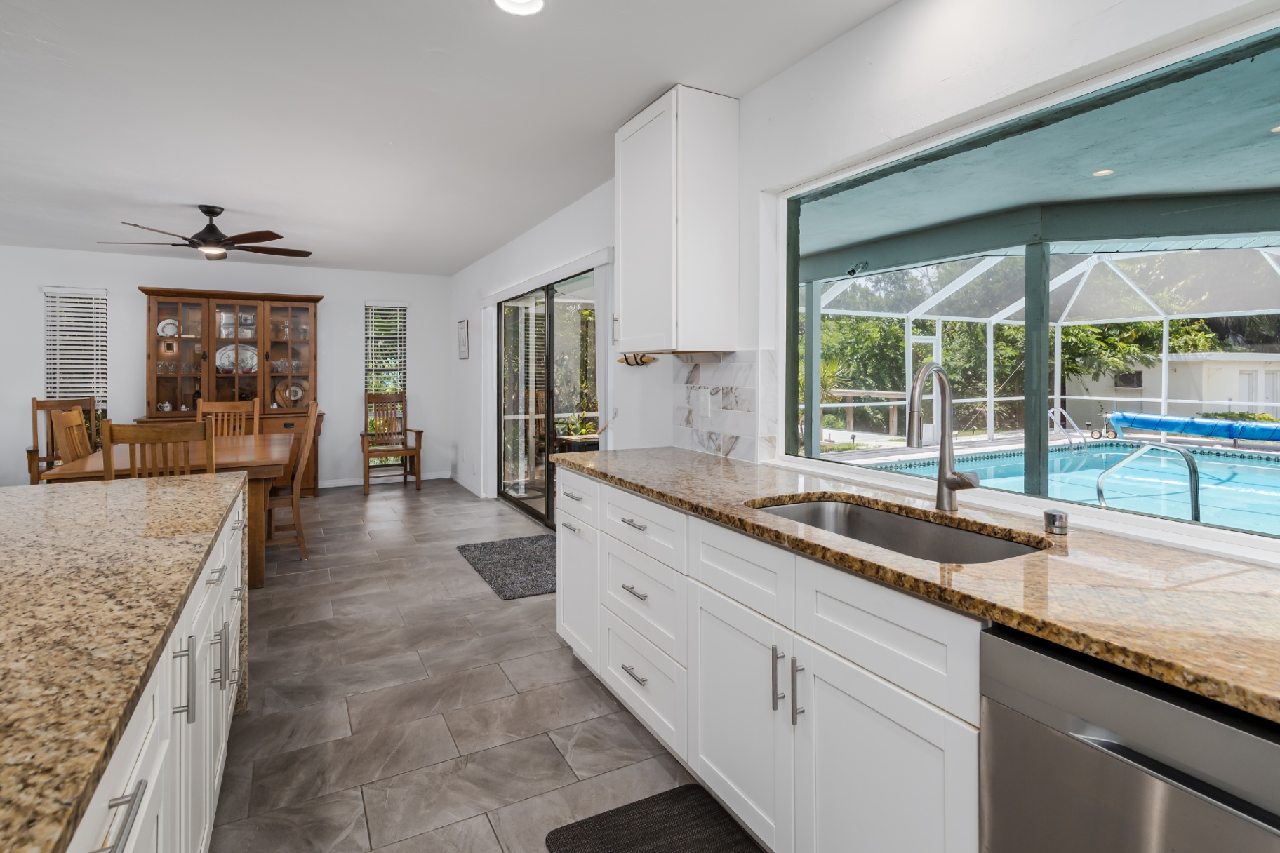 Chef's kitchen with pass-through window overlooking the pool